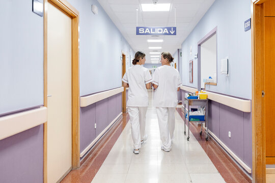 Nurses walking hospital corridor providing healthcare services