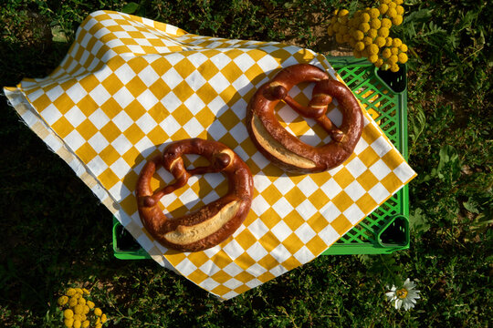 Golden Pretzels On Checkered Yellow And White Cloth For Summer Picnic