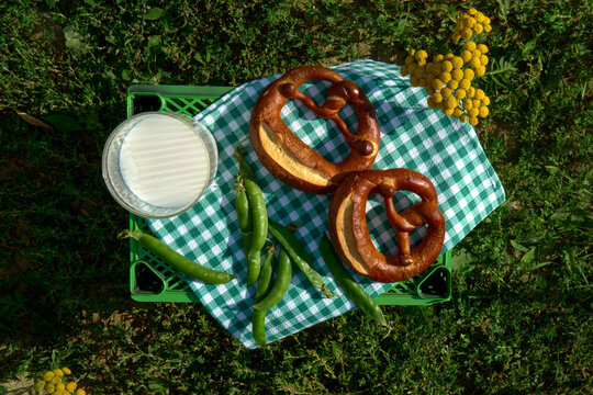 Golden Pretzels With Milk And Green Peas For Summer Picnic