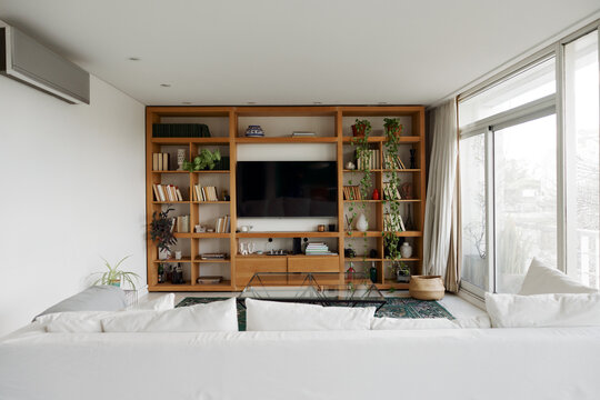 Modern Living Room With a Large Bookshelf and TV Setup