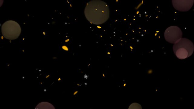 Golden confetti falling against a dark background with soft glowing bokeh lights.