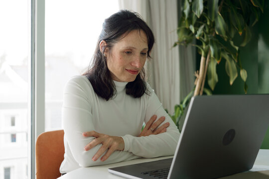 Woman Working on Laptop at Home Office During Daytime