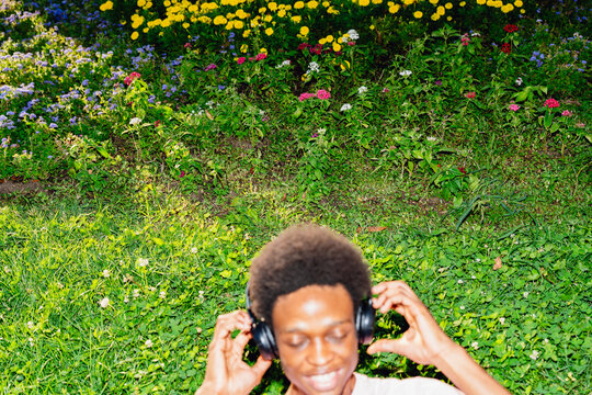 Adjusting Headphones On Grass