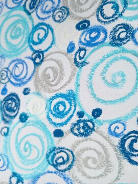 A continuous background pattern of blue, light blue, and silver spirals and swirls on white.