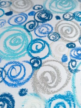 A continuous background pattern of blue, light blue, and silver spirals and swirls on white.