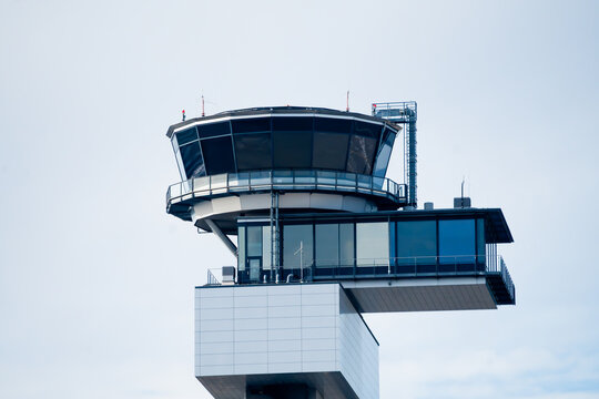 View of the modern control tower at Frankfurt Airport with its distinctive glass cabin and white structure against a clear sky in Frankfurt am Main, Hessen, Germany.