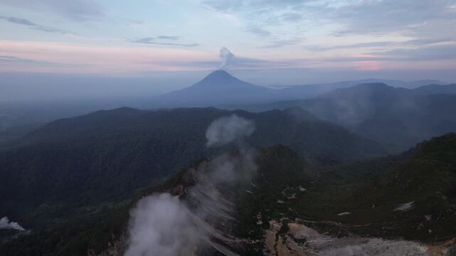 Drone video from the summit of an active volcano, Mount Sabayak with Mount Sinabung in the background, North Sumatra, Indonesia