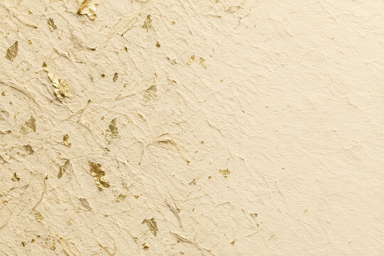 Textured handmade paper background with gold leaf flakes, cream colored fibrous surface, elegant organic pattern. Luxury stationery, wedding invitation template, fine art backdrop.