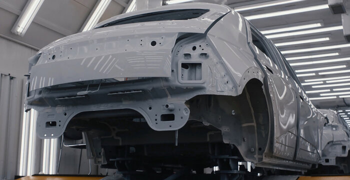 View of a car body frame on an assembly line in a modern automotive manufacturing factory in Jilin City, Jilin, China.
