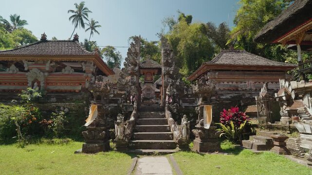 Traditional stone entrance and sacred water pools at Pura Gunung Kawi Sebatu Hindu temple in Ubud, Bali, Indonesia