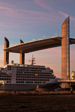 A cruise liner sails under a bridge Pont Jacques Chaban Delmas in the city of Bordeaux.