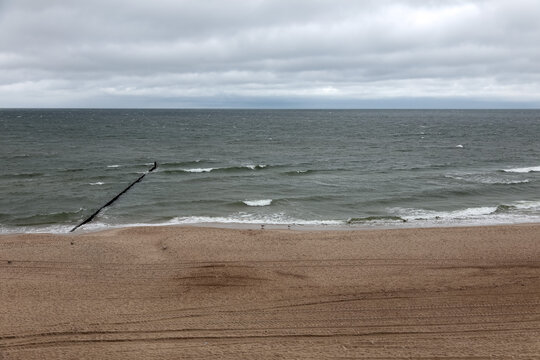 On an overcast and brisk day, the beach in Mielno, Poland, is empty