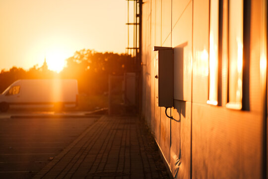 View of a building wall with an electrical box during a warm sunset in Sremska Mitrovica, Vojvodina, Serbia.