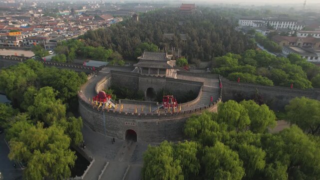Aerial View of Ancient Chinese City Wall and Fortress in Pingyao with Greenery in Pingyao, China