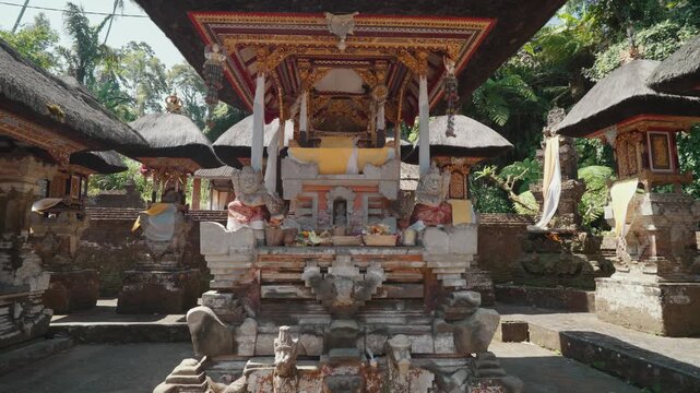 Traditional stone entrance and sacred water pools at Pura Gunung Kawi Sebatu Hindu temple in Ubud, Bali, Indonesia