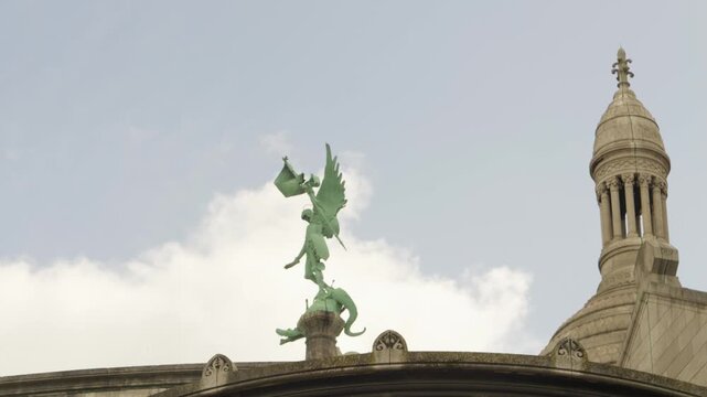 Winged Sculpture and Historic Dome of Sacr&eacute;-C&oelig;ur Basilica in Montmartre, Paris, France
