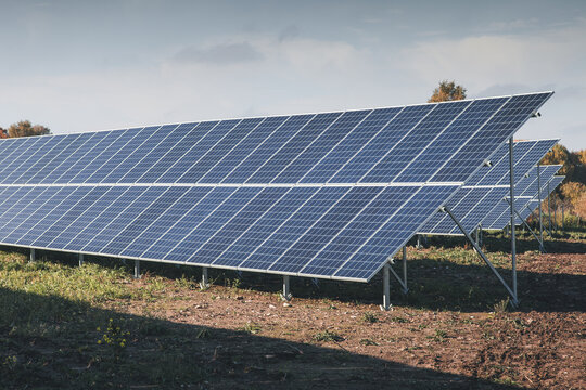 View of solar panels installed in a rural field under a clear blue sky in Tartu County, Estonia.