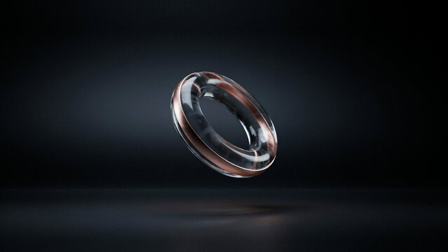 A single floating ring made of dark transparent glass with a subtle metallic rim on black background