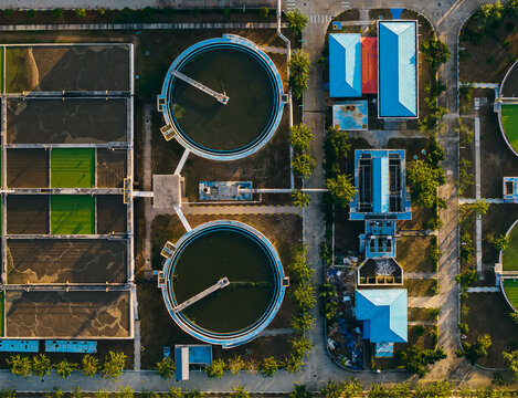 Wastewater clarifier tanks arranged beside plant buildings