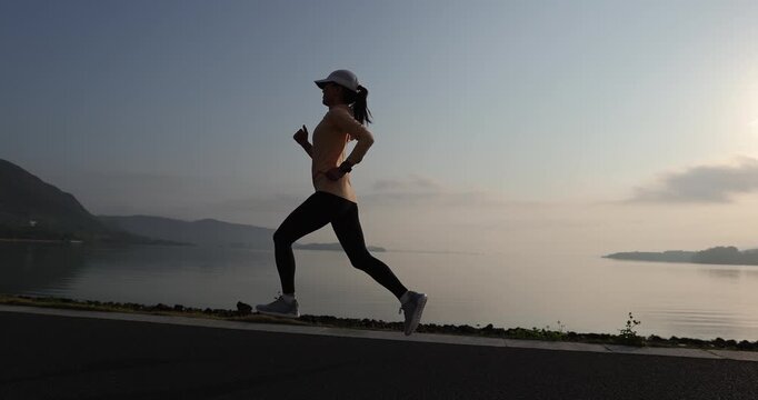 Fitness woman runner running at seaside	