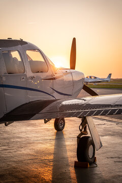 View of a private airplane parked on the tarmac at Hannover Airport during golden hour in Langenhagen, Niedersachsen, Germany.