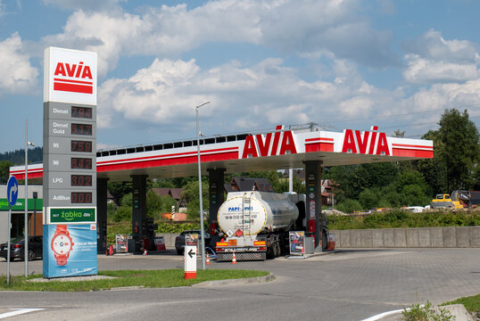 AVIA petrol station canopy with fuel tanker truck refuelling, price totem