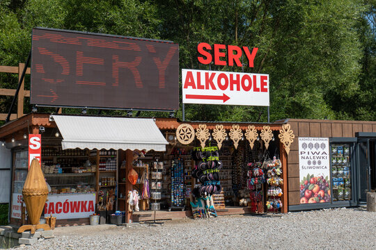 Wooden roadside shop in Poland selling cheese and regional alcohol