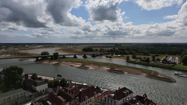 Overview of wide IJssel river winding through Dutch river countryside