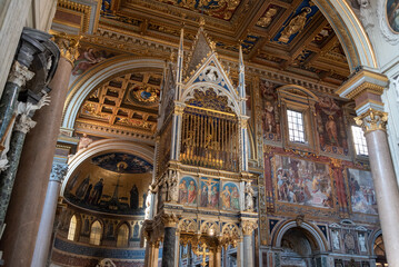 Rome, Italy - April 10, 2026 - Close-up View of the Upper Section and Gilded Tracery of the Gothic Baldachin in the Lateran Basilica, Rome © imagoDens