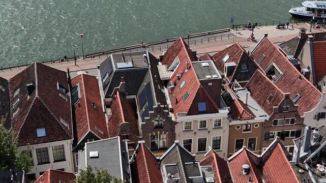 Top down overhead view of historic red house roofs and IJssel riverbank