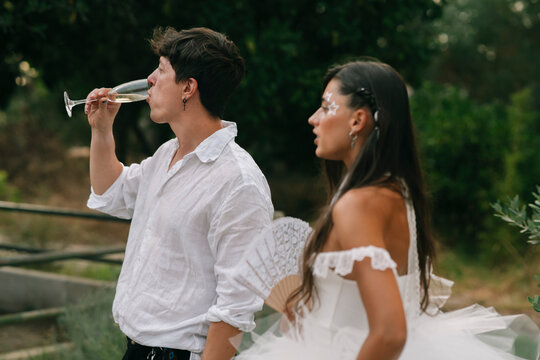 Groom Drinking Beside Bride At Reception