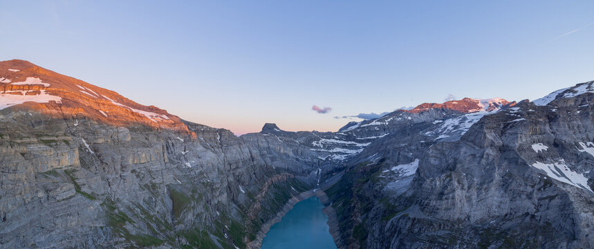 Scenic aerial view of Limmernsee reservoir near Muttenchopf, showing dramatic alpine peaks and rugged terrain in the Swiss Alps of Glarus