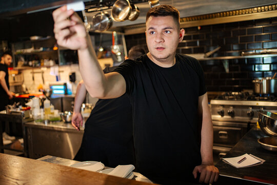 Chef looking at order tickets, managing kitchen operations