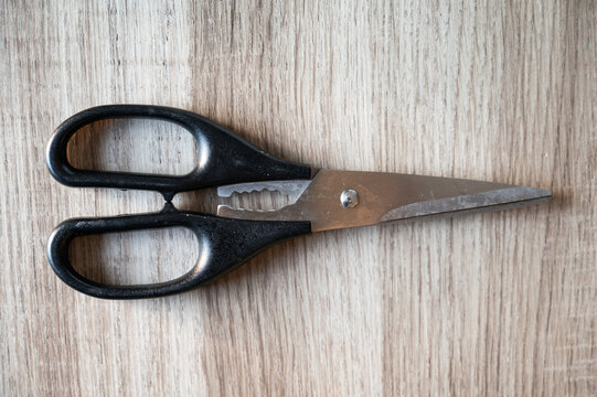 Scissors with black plastic handles on a table