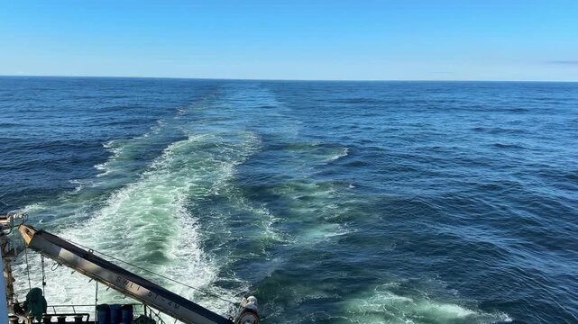 astern of the vessel at the ocean.