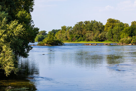 The Garonne river at the Parc de la Confluence in Portet-sur-Garonne in summer, after the drought episodes of 2026, within the R&eacute;serve Naturelle de la Confluence Garonne-Ari&egrave;ge