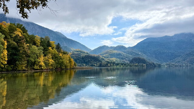Scenic autumn mountain landscape framed by foliage at Kochelsee Germany for travel editorial