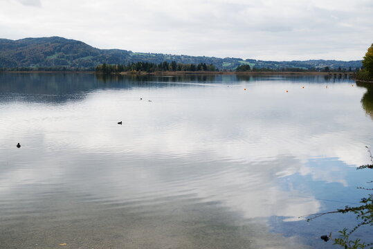 Minimalist lake surface with sky reflection and copy space Kochelsee Germany for background
