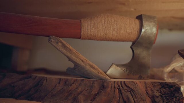 Close up view of tools and materials used in carpentry. axe rests on rough cut lumber emphasizing texture details like wood grain patterns or tool handle wrapping