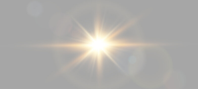 Golden lens flare with sunburst rays on neutral background. Bright optical lighting flare effect for design overlay
