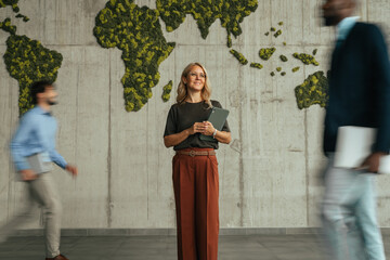 Businesswoman standing in modern office with global map © Miljan Živković
