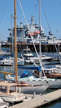 Falmouth Cornwall England UK. 21.08.2026. Video. Boats in marina with a naval vessel in background of Falmouth harbour UK