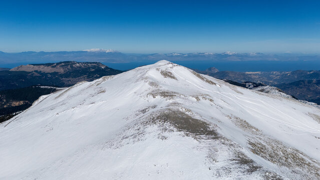 Aerial view of snowy Mount Zireia summit in Corinthia, Greece, Mount Kyllini