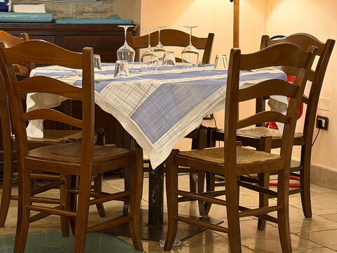 Restaurant table full of delicious gourmet food, appetizers and wine glasses.