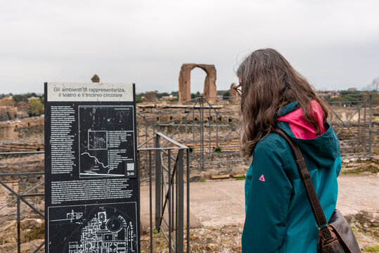 Female Tourist Reading Information Board at Villa dei Quintili Rome