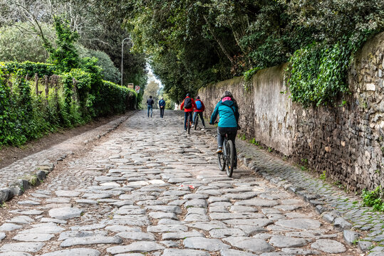 Young Woman Cycling on Via Appia Antica, Rome