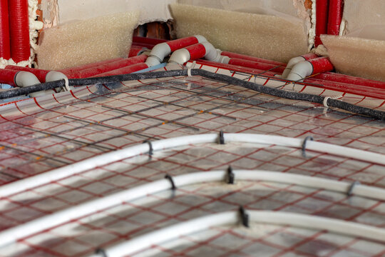 New house with radiant floor heating tubing fixed in place before concrete pour. Sustainable building technology, warmth and indoor comfort concept.
