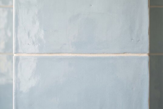 Pale ceramic wall tiles with a single clean grout line