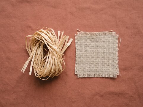 Small spool of raffia beside a woven sample