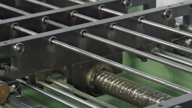 Watch as an industrial machine expertly shapes copper tubes in slow motion, showcasing the intricate process of manufacturing essential components for air conditioning systems.